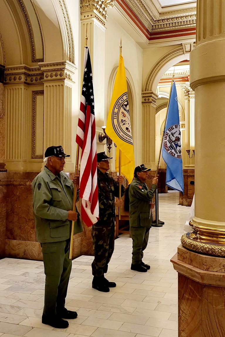 Southern Ute Veterans hold the flags of the Southern Ute Indian Tribe, Ute Mountain Ute Tribe, and the United States flag.