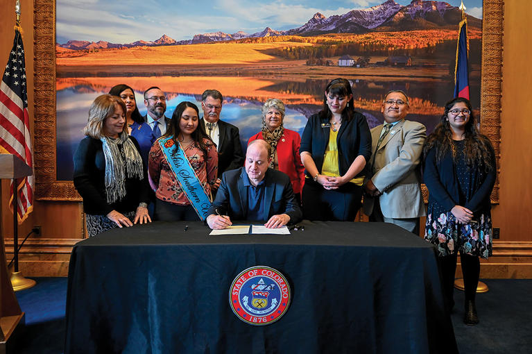 Governor Polis signing a bill into law